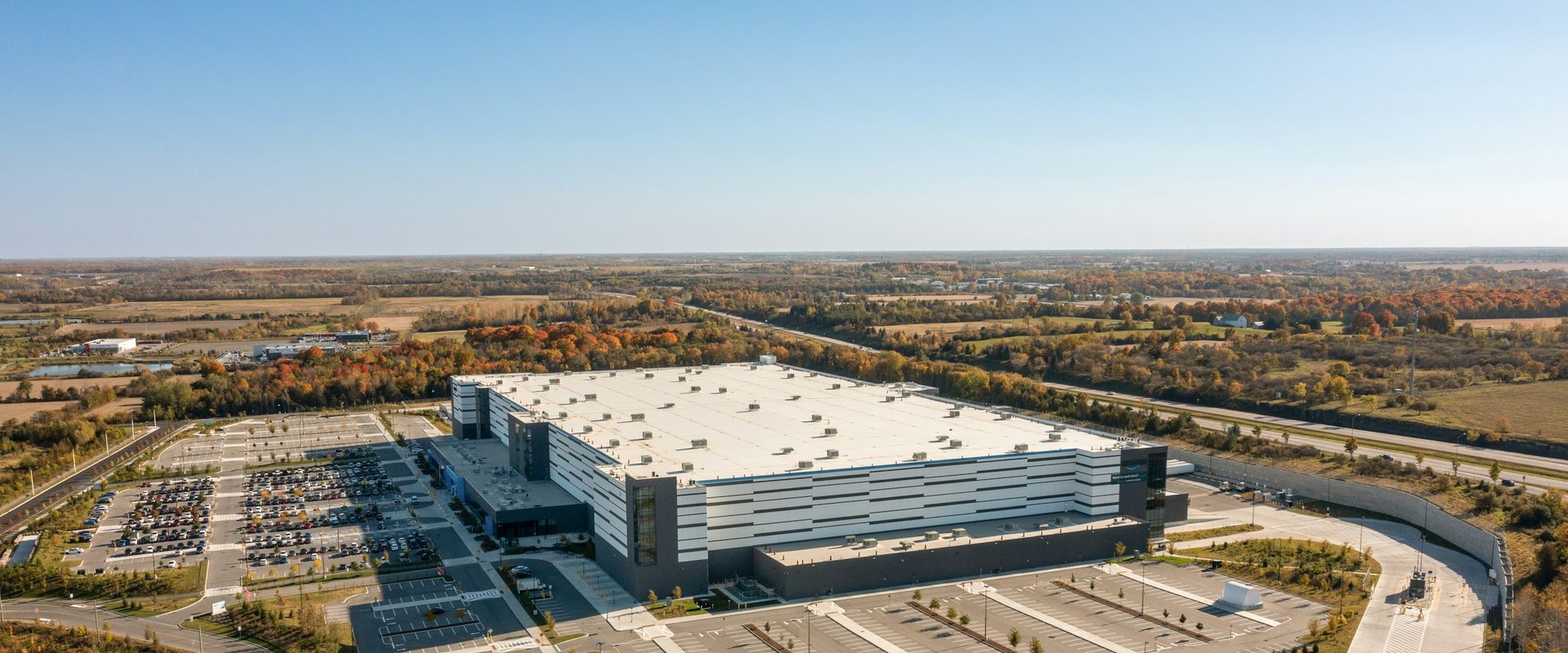 Modern distribution center with parking lot viewed from a distance